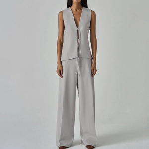 Three-piece suit with lapel blazer, lace-up vest and wide-leg trousers in light grey