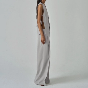 Detailed side view of grey vest with tie-up closure and high waist wide leg trousers