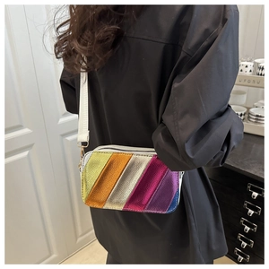 Detailed shot of a rainbow-striped crossbody bag with metallic colors and wide strap