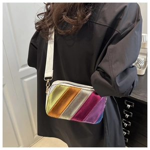 Close-up of rainbow striped crossbody bag with metallic PU finish and adjustable white strap