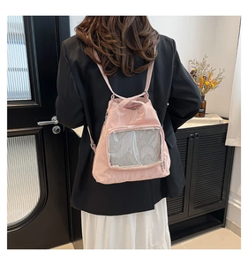 Detail of pink nylon backpack with a transparent PVC window and white mesh lining
