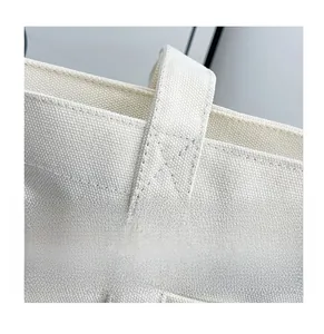 Detail of reinforced X-shaped stitching on high-quality canvas tote bag strap