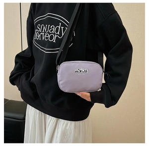 Close-up of a light purple canvas cosmetic bag with a panda print and black strap