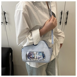 Detail of light blue ita bag showing transparent PVC window with character pins
