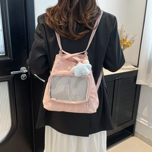 Pink minimalist backpack with front mesh pocket and star charm shown on a model