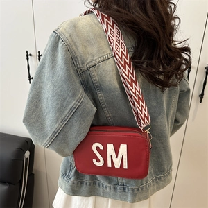 Fashionable red square crossbody bag with SM logo and wide zigzag fabric strap