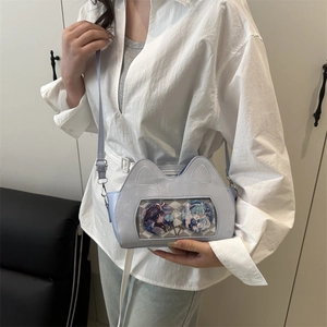 Light blue cat-ear ita bag with transparent window showing anime pins for women