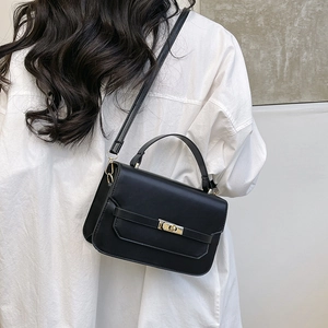 Chic black minimalist leather crossbody bag with gold twist lock and top handle for women