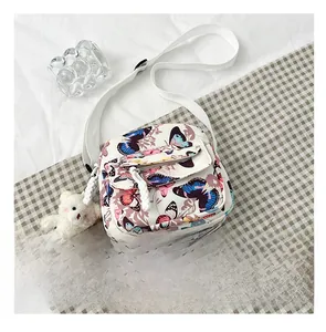 Detailed size reference showing a floral butterfly crossbody bag with a plush bear charm