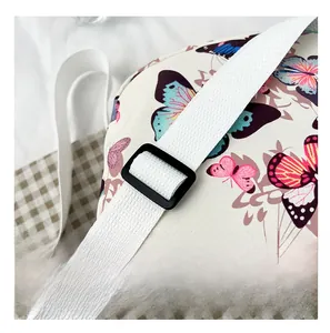 Detail view of the shell bag showing the adjustable white strap and black plastic buckle