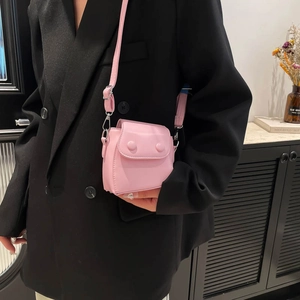 Chic light pink mini crossbody bag for women with dual round buckles and slim shoulder strap