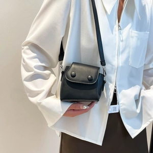 Minimalist black mini square crossbody bag with round decorative buckles and silver hardware