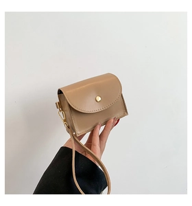 Detail of khaki quilted leather mini pouch with gold snap button and wristlet strap