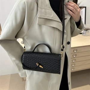Black woven faux leather crossbody bag with gold knot lock and slim shoulder strap