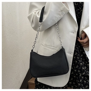 Detail of black crescent shoulder bag with ribbed texture and silver chain strap