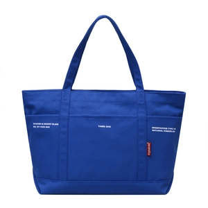 Minimalist navy blue canvas tote bag with white letter print and dual top handles