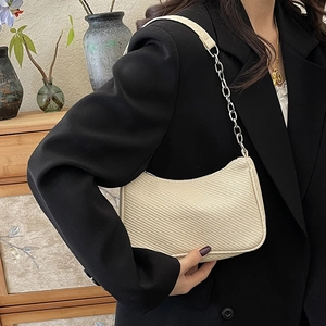 Minimalist off-white crescent hobo bag with textured weave and metal chain strap