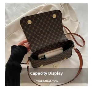Interior capacity display of brown vintage patterned bag showing space for phone and wallet