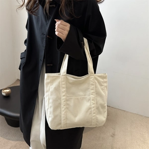 Large cream corduroy tote bag for women showing a minimalist design and soft texture