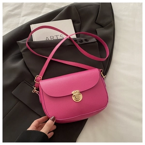 Detailed macro shot of fuchsia pebble leather texture and golden circular metal lock