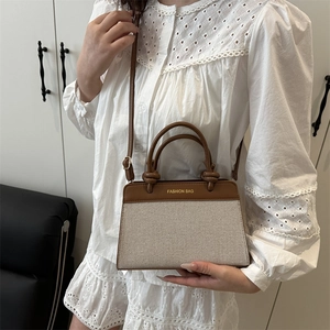 Chic canvas and brown leather tote bag with FASHION BAG text shown in a modern home interior