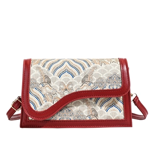 Traditional red Chinese brocade crossbody bag with classic wave pattern and leather trim