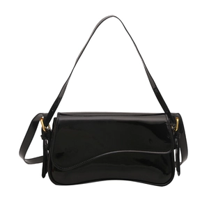 Glossy black patent leather shoulder bag with wavy flap and gold ring detail