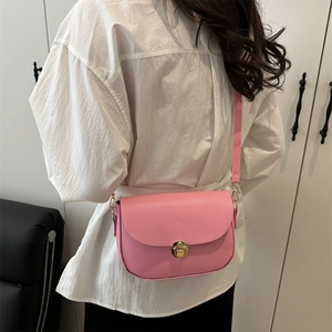 Pink lychee leather saddle bag with gold metal lock buckle and crossbody strap for women