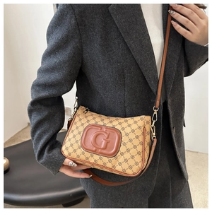 Detail of vintage monogram shoulder bag with gold G-logo and premium leather strap