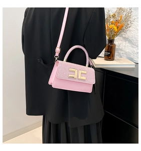 Detail of pink glitter patchwork crossbody bag with gold logo and adjustable strap