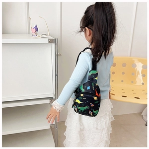 Detail of kids chest bag showing dinosaur space print and adjustable shoulder strap