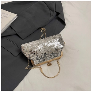 Detail view of silver sequin evening clutch with gold metal frame and bead clasp closure