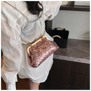 Detailed macro view of the sparkling purple sequin kiss-lock bag with gold chain strap