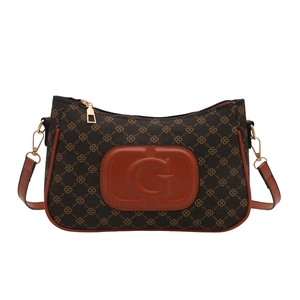 Retro underarm bag in dark brown chain pattern with embossed orange leather G logo