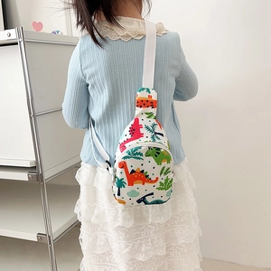 White canvas kids chest bag with colorful dinosaur prints and adjustable strap