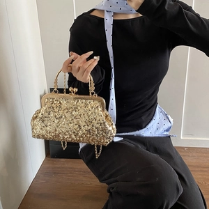 Elegant gold sequin evening clutch bag with ornate engraved metal handle and clip closure