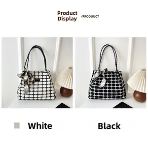 Detail view of large tweed plaid tote bags with woven handles and silk bow accessories