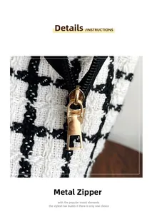 Close-up of golden hardware zipper on black and white tweed tote bag detail