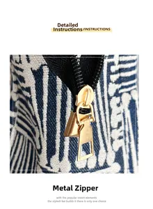 Detail view of the premium golden metal zipper and blue striped fabric on the tote bag