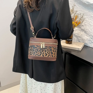 Vintage leopard print contrast bucket bag with gold zippers and adjustable shoulder strap