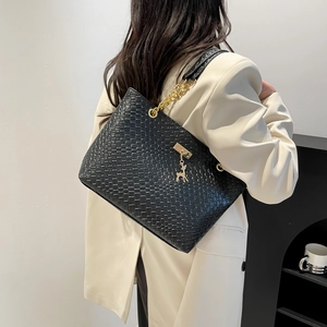 Minimalist black woven leather shoulder bag for women with gold chain and deer charm