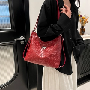 Stylish red woven shoulder bag with silver bow buckle for women, versatile crossbody style
