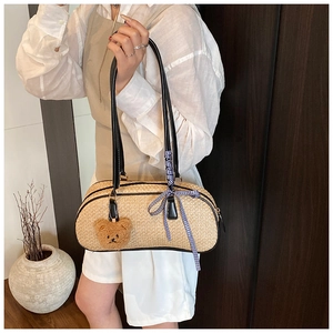 Chic straw shoulder bag featuring blue checkered ribbon and cute plush bear charm detail