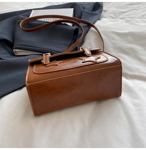Detailed view of the wide base and stitching on this retro brown faux leather crossbody bag