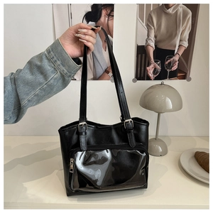 Detail of black PU leather tote with transparent PVC pocket and adjustable strap