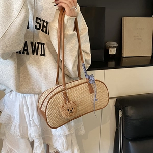 Chic woven underarm shoulder bag with brown leather handles and cute bear charm