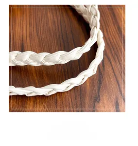 Close-up of white faux leather woven shoulder strap with intricate texture and craftsmanship