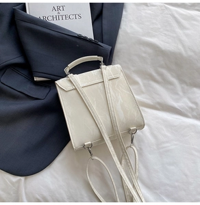 Detail view of white marble patterned mini square backpack with metallic handle