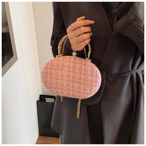 Pink tweed oval clutch bag with golden chain handle and pearl clasp detail