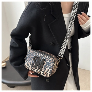 Close-up of leopard print crossbody bag with black SM logo and geometric wide strap